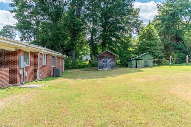 view of yard featuring a shed and central air condition unit