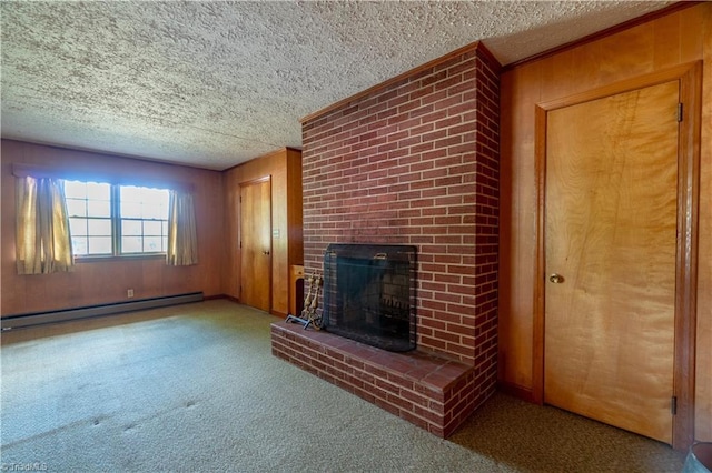 unfurnished living room featuring a fireplace, light carpet, baseboard heating, and wooden walls