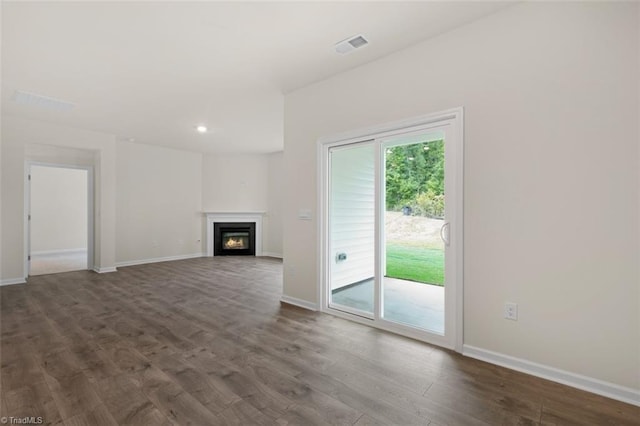 unfurnished living room featuring dark hardwood / wood-style floors