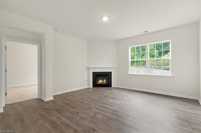 unfurnished living room featuring dark hardwood / wood-style flooring