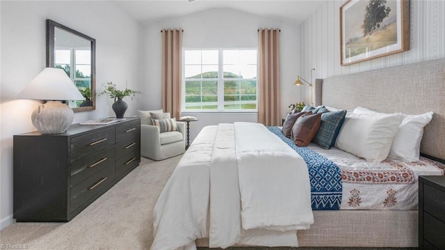 bedroom with vaulted ceiling and light colored carpet