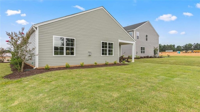 rear view of property with a yard