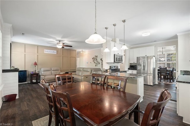 1951 Rubywood St, Greensboro, NC 27405 - dining area featuring a ceiling fan, dark wood-type flooring, crown molding, and a decorative wall