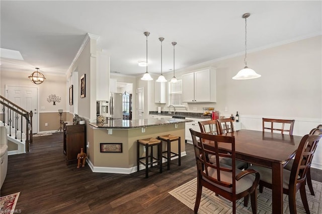 1951 Rubywood St, Greensboro, NC 27405 - dining room featuring dark wood-style floors, crown molding, and stairs