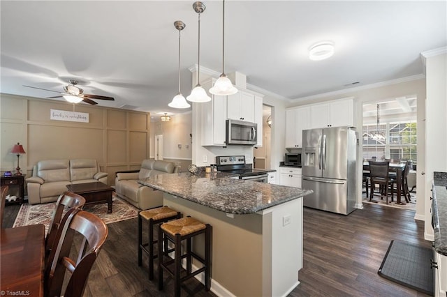 1951 Rubywood St, Greensboro, NC 27405 - kitchen featuring stainless steel appliances, a ceiling fan, a breakfast bar area, white cabinetry, and a peninsula