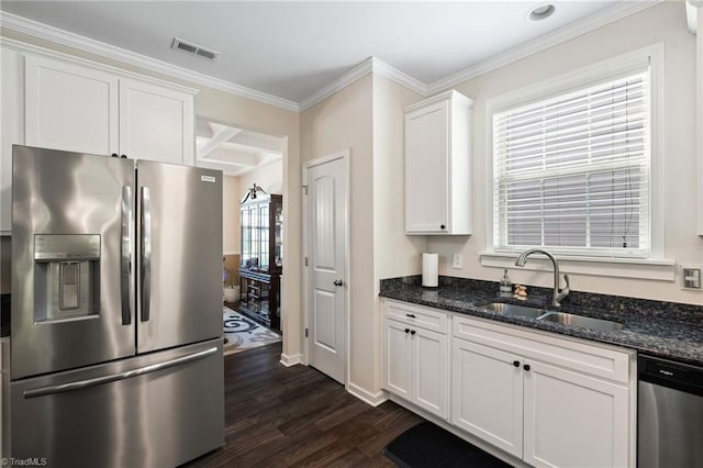 1951 Rubywood St, Greensboro, NC 27405 - kitchen with appliances with stainless steel finishes, dark wood-type flooring, white cabinets, dark stone countertops, and ornamental molding
