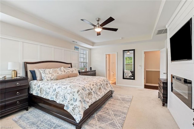 1951 Rubywood St, Greensboro, NC 27405 - bedroom with a tray ceiling, light carpet, ensuite bathroom, and a ceiling fan