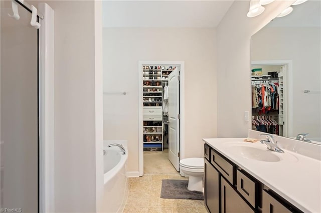 1951 Rubywood St, Greensboro, NC 27405 - full bath featuring a walk in closet, vanity, a bath, and tile patterned flooring