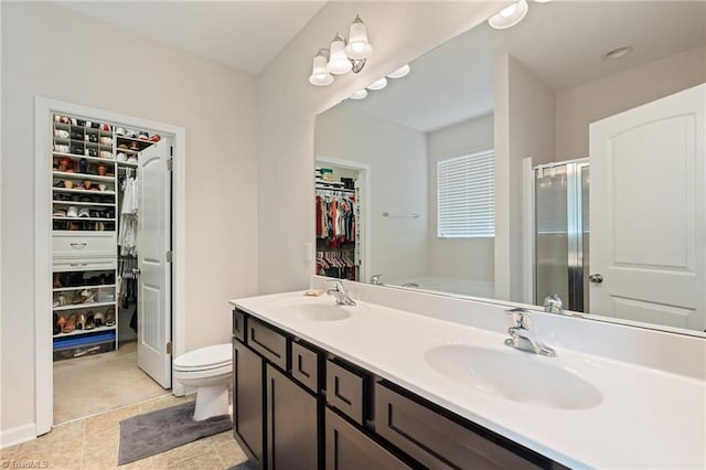 1951 Rubywood St, Greensboro, NC 27405 - bathroom featuring a walk in closet, double vanity, a stall shower, and a bath