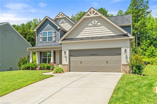 1951 Rubywood St, Greensboro, NC 27405 - craftsman-style house featuring a garage, board and batten siding, concrete driveway, a front yard, and brick siding