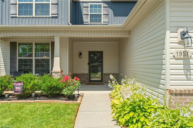 1951 Rubywood St, Greensboro, NC 27405 - view of exterior entry with covered porch, board and batten siding, and brick siding