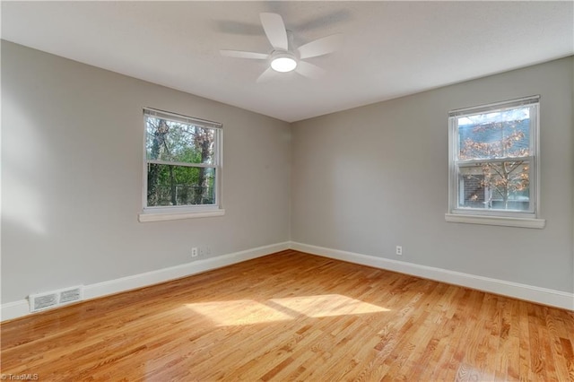 unfurnished room with ceiling fan, plenty of natural light, and light hardwood / wood-style flooring