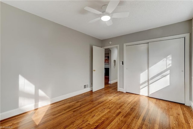 unfurnished bedroom featuring a closet, ceiling fan, and light hardwood / wood-style flooring