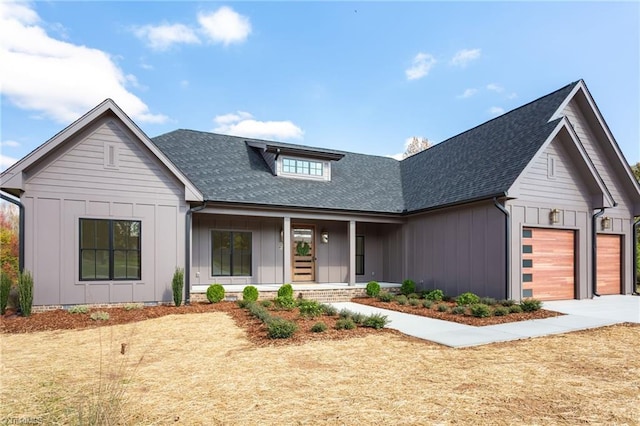 modern inspired farmhouse featuring a porch and a garage