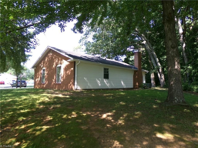 203 Turkey Hill Dr, King, NC 27021 - view of side of property featuring a chimney, brick siding, and a yard