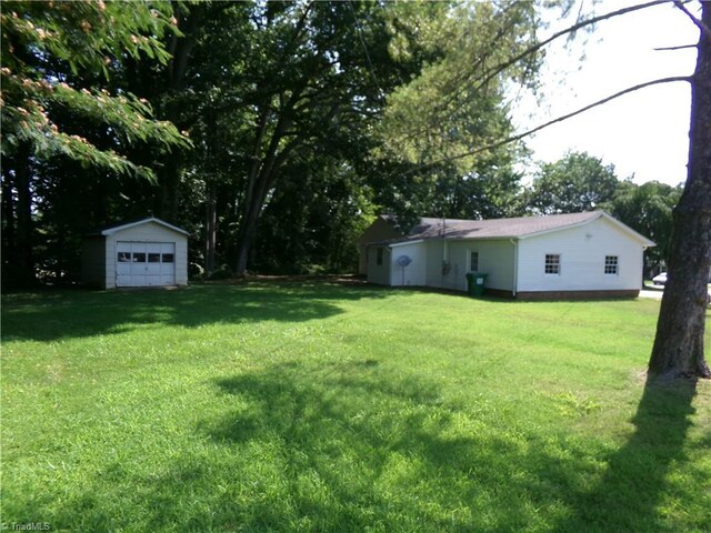 203 Turkey Hill Dr, King, NC 27021 - view of green lawn with a garage and an outbuilding
