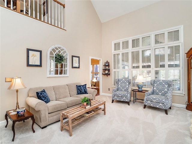 carpeted living room featuring a towering ceiling and a wealth of natural light