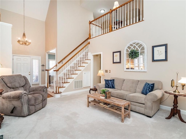 carpeted living room with an inviting chandelier and a high ceiling