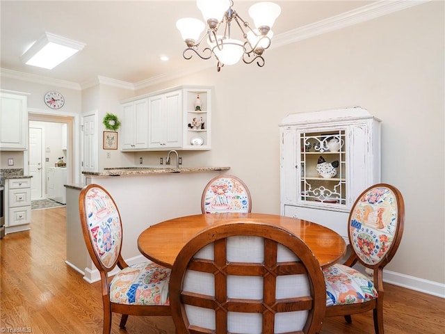 dining space with a notable chandelier, crown molding, and light hardwood / wood-style flooring