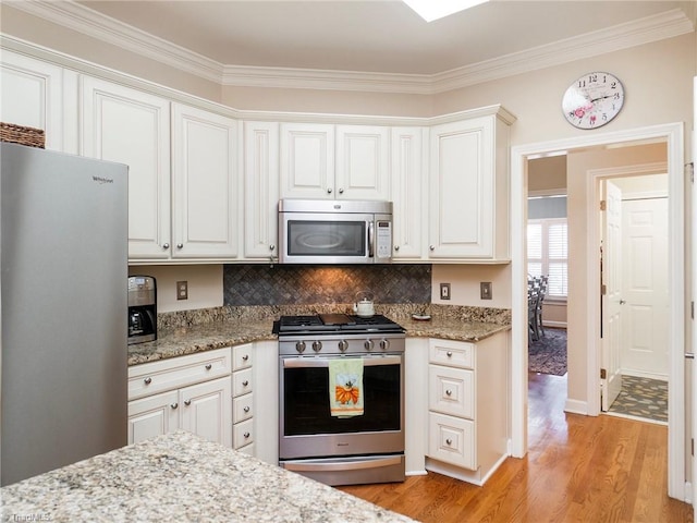 kitchen featuring light hardwood / wood-style flooring, stainless steel appliances, and white cabinets