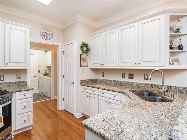 kitchen featuring crown molding, sink, white cabinets, and light hardwood / wood-style flooring