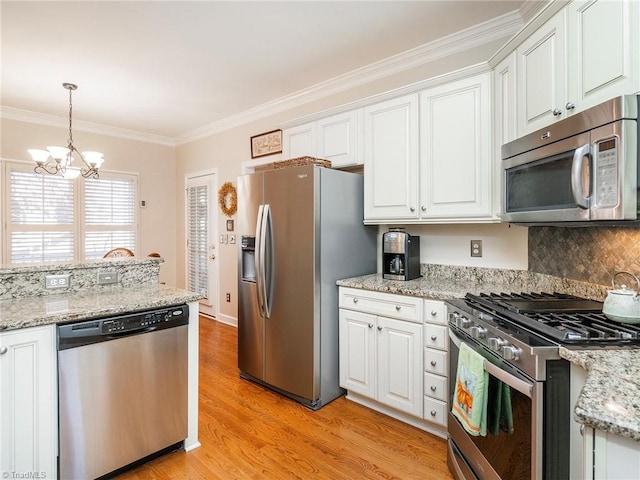 kitchen with white cabinetry, pendant lighting, and stainless steel appliances