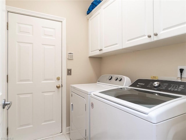 laundry room with washer and clothes dryer and cabinets