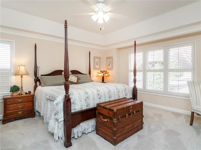 bedroom featuring ceiling fan, ornamental molding, and light carpet