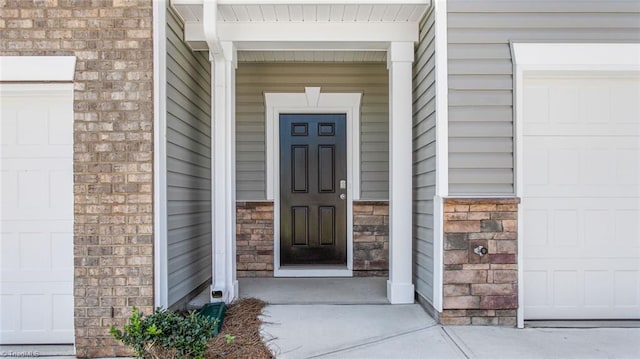 doorway to property featuring a garage