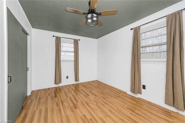 unfurnished bedroom with light wood finished floors and a ceiling fan