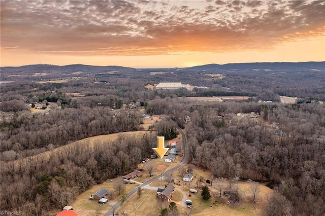 aerial view at dusk featuring a mountain view