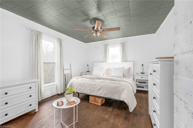 bedroom with dark wood-type flooring and ceiling fan