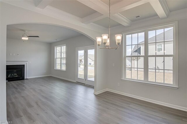 unfurnished living room featuring beam ceiling, visible vents, baseboards, and wood finished floors