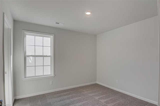 carpeted spare room with recessed lighting, visible vents, and baseboards