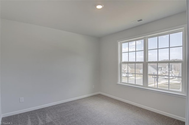 carpeted spare room with recessed lighting, visible vents, and baseboards