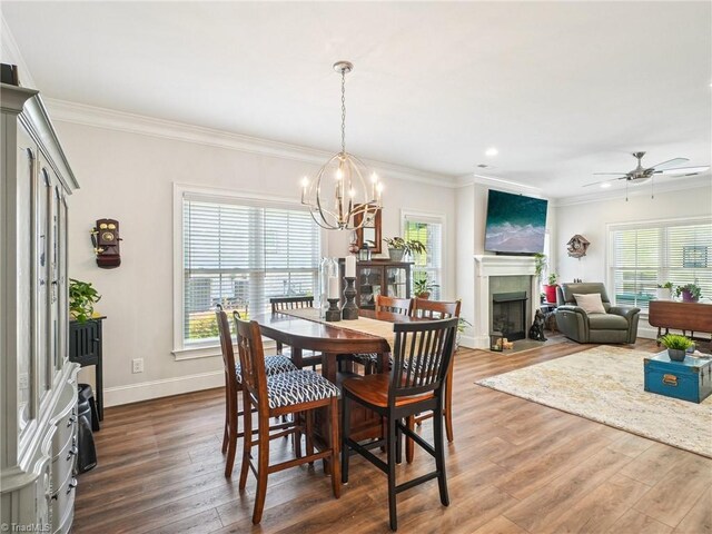 1659 Angus Ridge Dr, Kernersville, NC 27284 - dining room with wood finished floors, crown molding, a chandelier, recessed lighting, and a fireplace