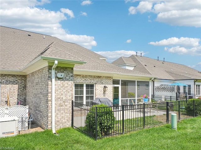 1659 Angus Ridge Dr, Kernersville, NC 27284 - back of house featuring a shingled roof, a sunroom, and brick siding