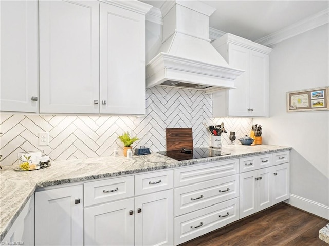 1659 Angus Ridge Dr, Kernersville, NC 27284 - kitchen with custom range hood, black electric stovetop, crown molding, white cabinets, and decorative backsplash