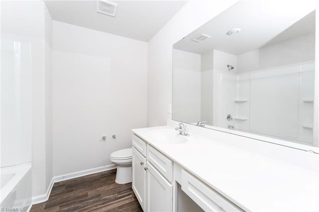 full bathroom featuring hardwood / wood-style flooring, vanity, toilet, and  shower combination