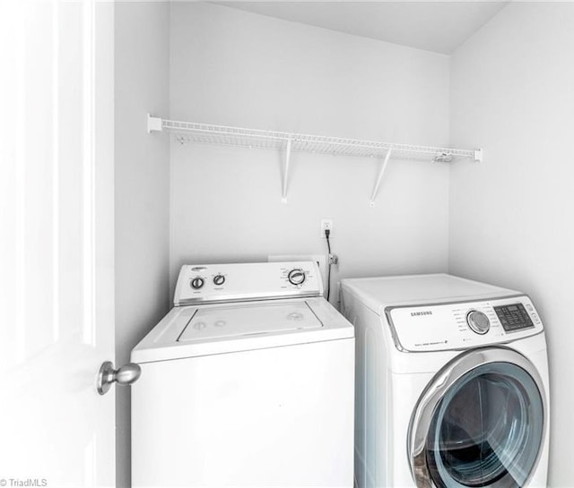 clothes washing area with washer and dryer