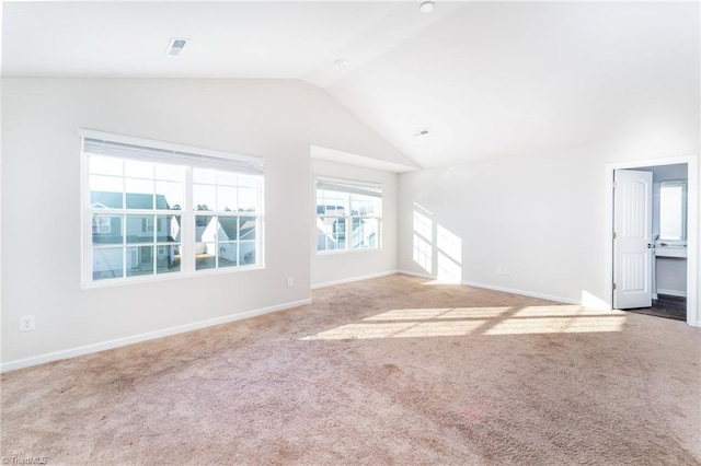 unfurnished living room with lofted ceiling and carpet