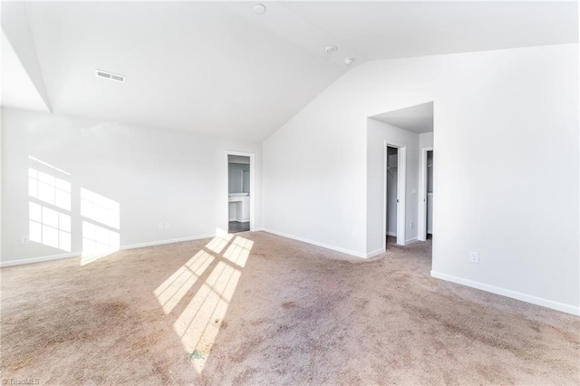 empty room with lofted ceiling and carpet