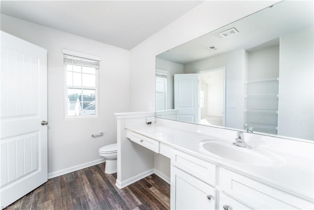 bathroom with vanity, hardwood / wood-style flooring, toilet, and a healthy amount of sunlight