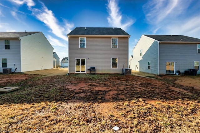 back of house featuring central AC unit