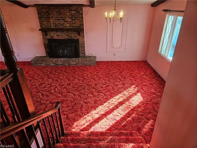 112 Balcony Ln, Mount Airy, NC 27030 - carpeted living room with a chandelier, beam ceiling, and a brick fireplace