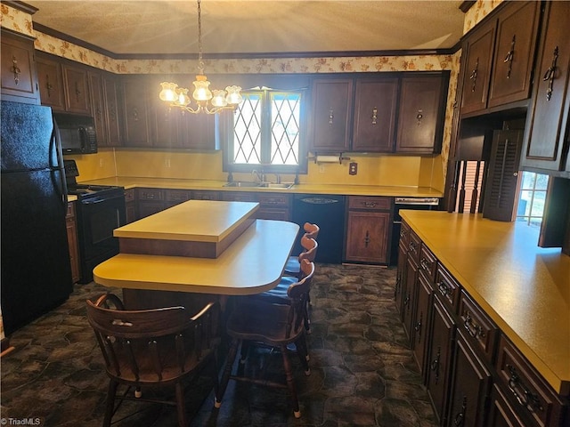 112 Balcony Ln, Mount Airy, NC 27030 - kitchen featuring pendant lighting, an inviting chandelier, black appliances, sink, and dark brown cabinetry
