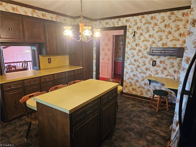 112 Balcony Ln, Mount Airy, NC 27030 - kitchen with decorative light fixtures, a center island, dark brown cabinetry, and an inviting chandelier
