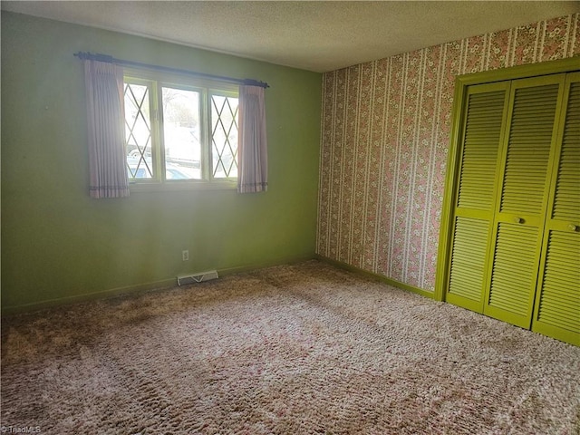 112 Balcony Ln, Mount Airy, NC 27030 - unfurnished bedroom with a textured ceiling, carpet floors, and a closet