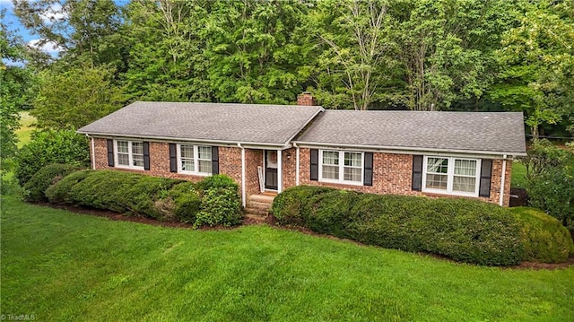 4345 Mcintyre Rd, Gibsonville, NC 27249 - ranch-style home featuring a front yard, a chimney, brick siding, and roof with shingles