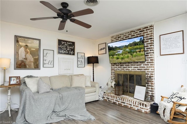 4345 Mcintyre Rd, Gibsonville, NC 27249 - living room featuring wood finished floors, ceiling fan, and a brick fireplace